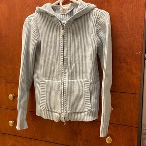 light blue sweater with hood.  Zip closure.  Slant pockets